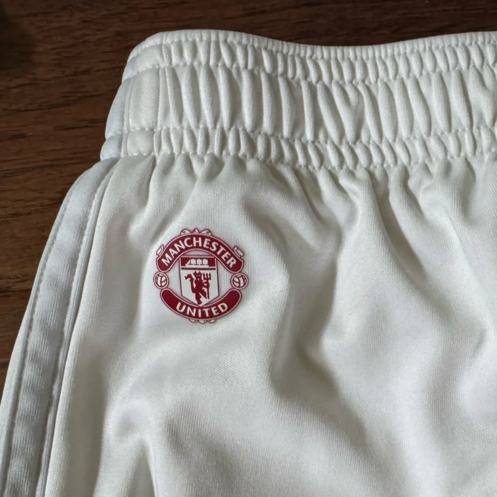 White Adidas Soccer Shorts with Red Manchester United Logo, size Medium 11-12Y